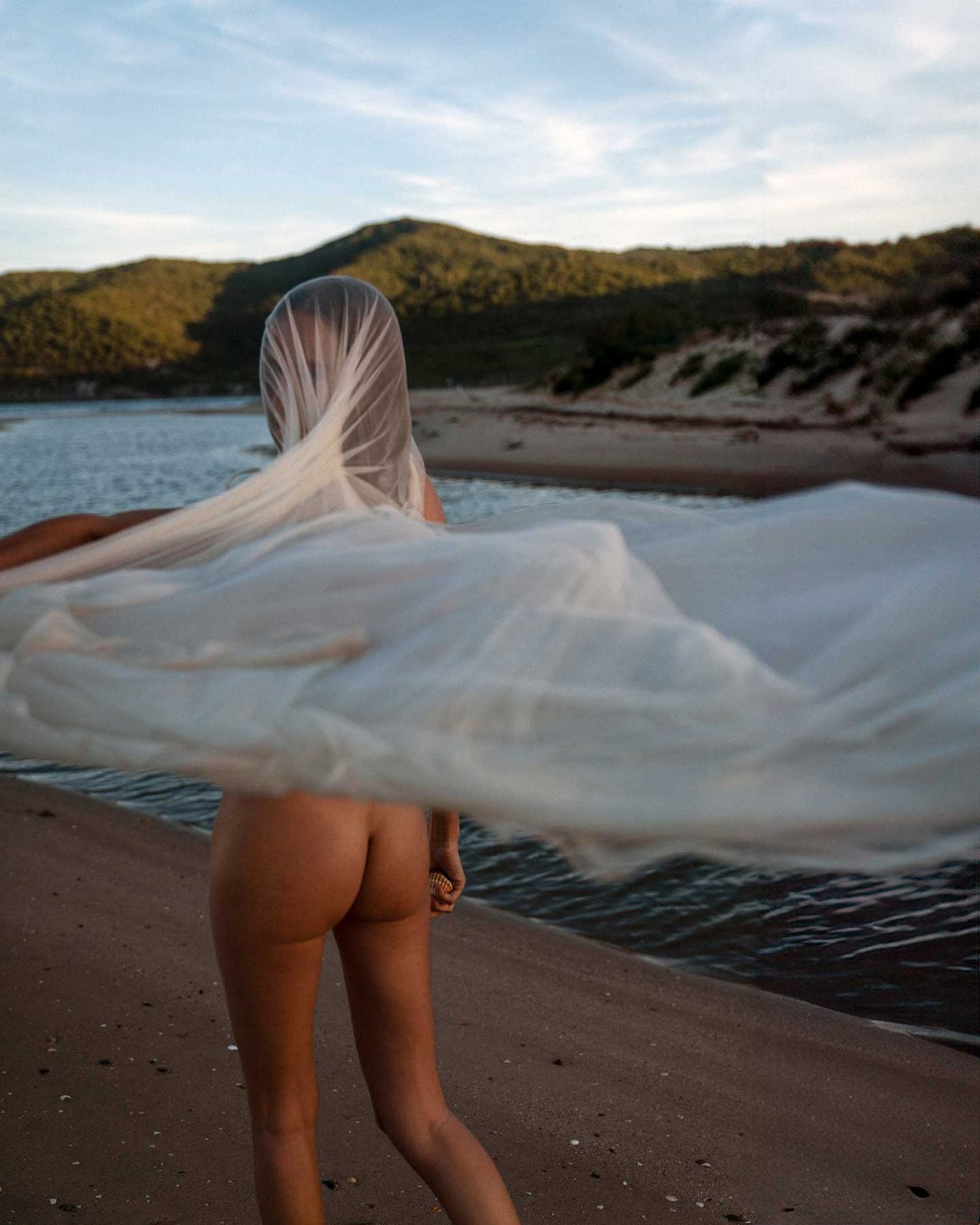 Brisa Singer and model Brisa Fenoy in an editorial portrait for Río Pícaro, photographed at sunset on Getares Beach, Algeciras. By Raúl Rosillo.