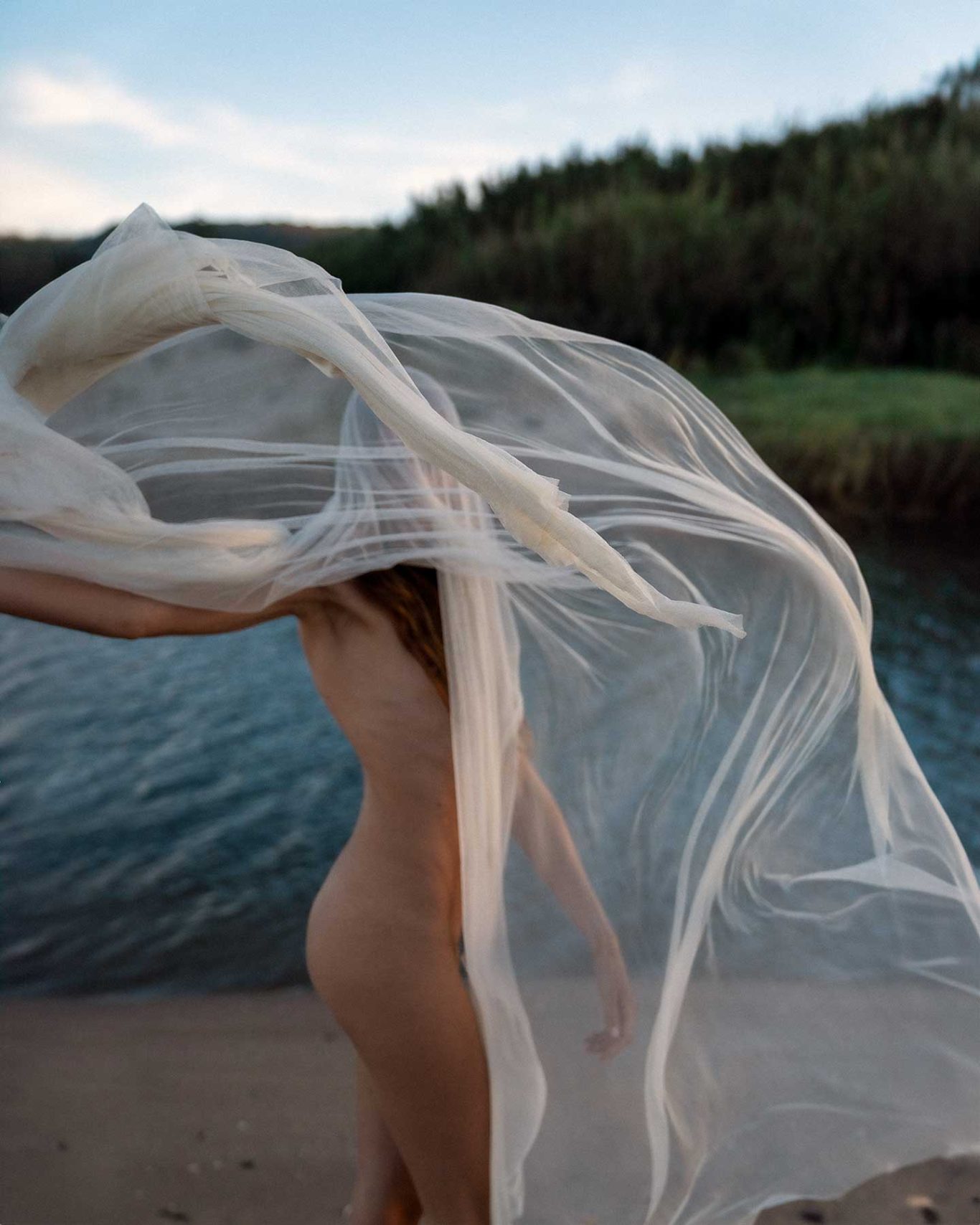Brisa Singer and model Brisa Fenoy in an editorial portrait for Río Pícaro, photographed at sunset on Getares Beach, Algeciras. By Raúl Rosillo.